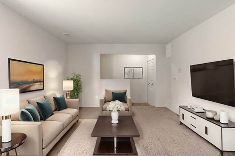 A living room with a couch, a coffee table, a lamp, a plant, and a painting on the wall.