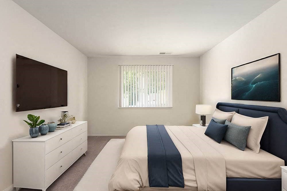 a bedroom with a bed and a tv in it