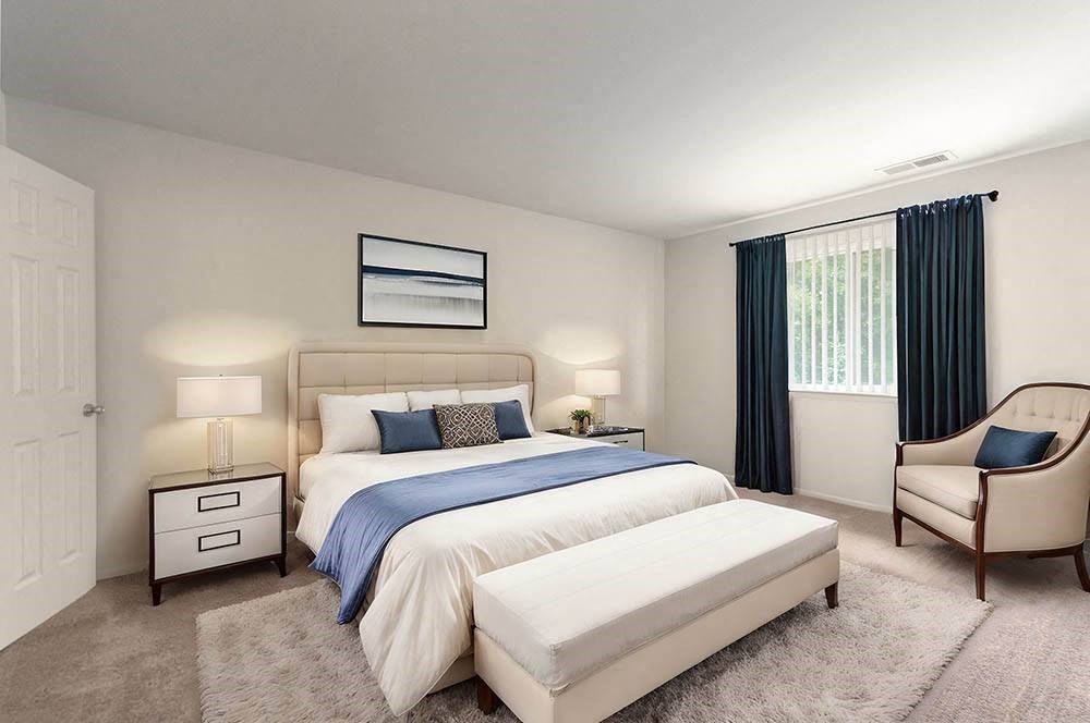 a bedroom with a bed and a chair