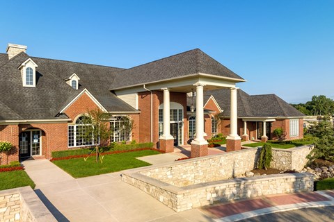 a large brick house with columns and a porch