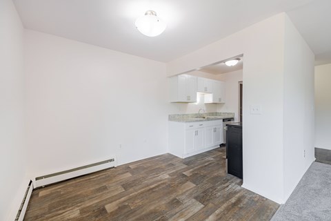 A room with a wooden floor and white walls.