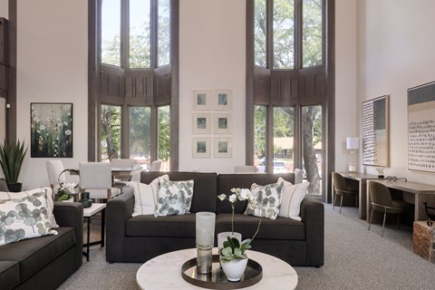 A living room with a couch, chairs, and a coffee table.