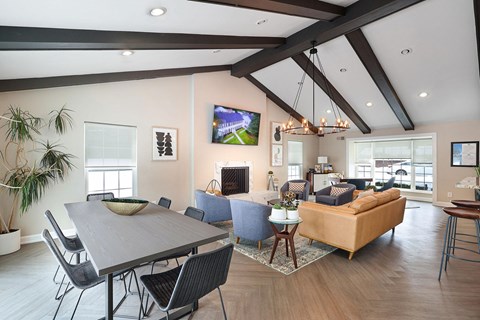 A modern living room with a large grey table and a blue sofa.