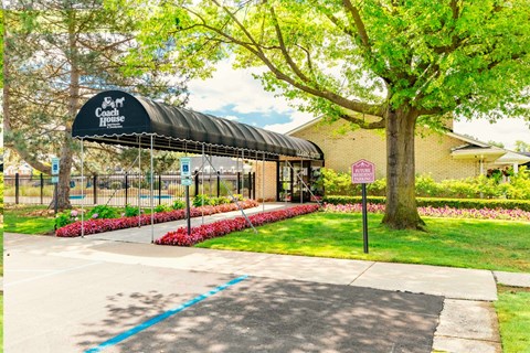 A black canopy with white lettering reads "The Coach House.".