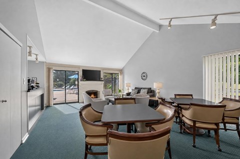 A dining room with a table and chairs.