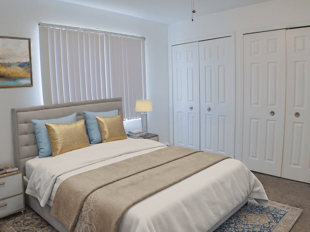 A bedroom with a large bed and a painting on the wall.