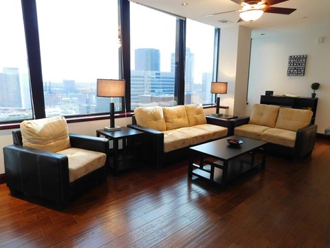 A living room with a large window overlooking the city.