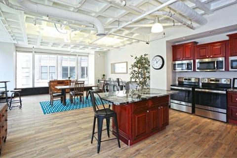 A kitchen with wooden floors and a large island in the middle.