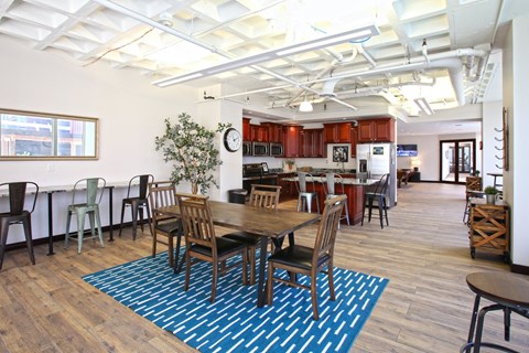 A dining room with a table surrounded by chairs.
