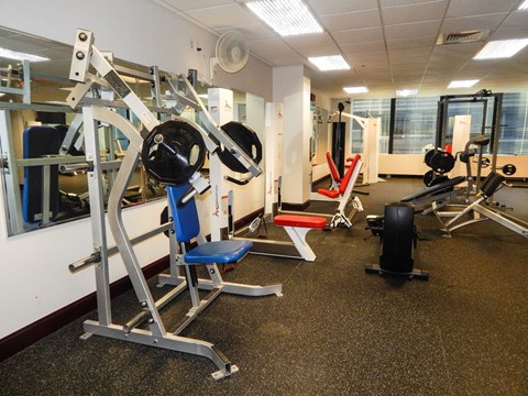 A gym with a variety of equipment including a leg press machine.