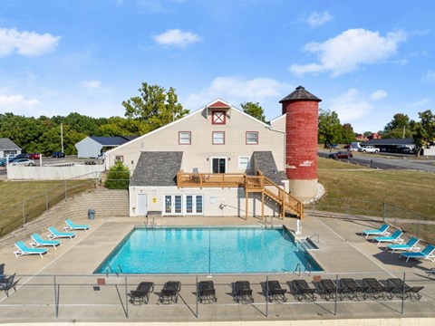 A pool area with a building and a red tower.