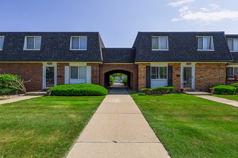 A row of houses with a walkway in the middle.