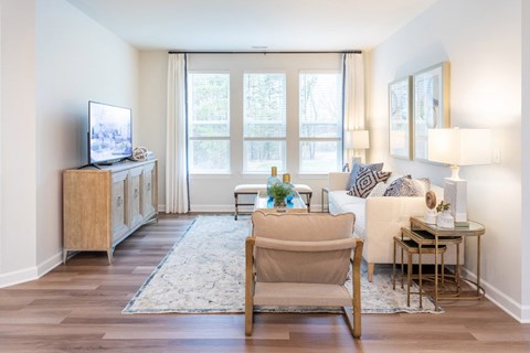 A living room with a television, a chair, and a table.