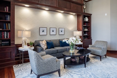 a living room with a couch and chairs and a table