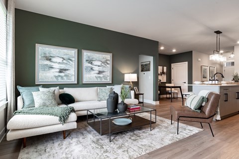 a living room with green walls and a white couch