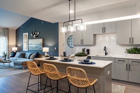 A modern kitchen with a dining table and chairs.