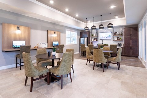 A modern dining room with a large table and chairs.