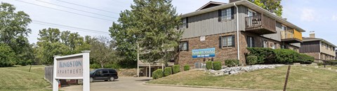 A building with a sign that says Kingston Apartments.