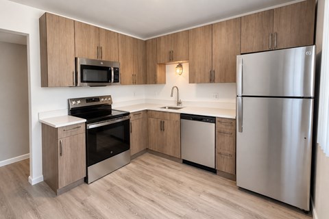 A kitchen with wooden cabinets and stainless steel appliances.