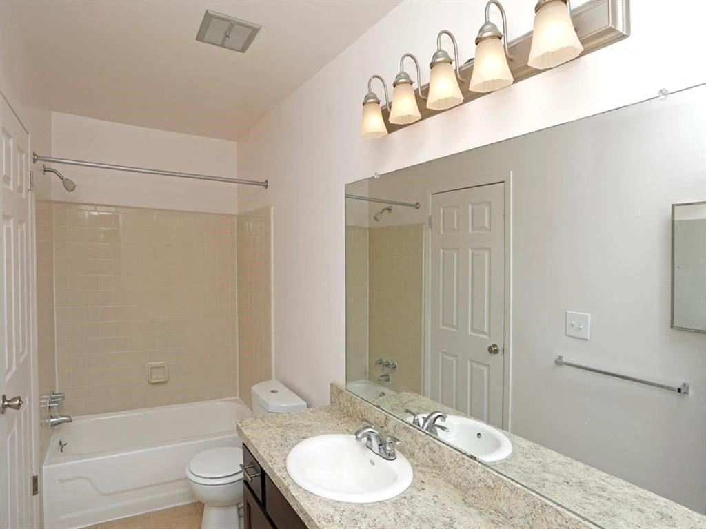 a bathroom with a sink and a toilet and a mirror