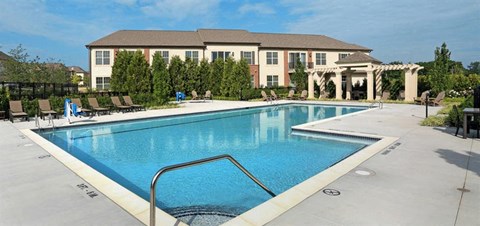 a large swimming pool with a hotel in the background