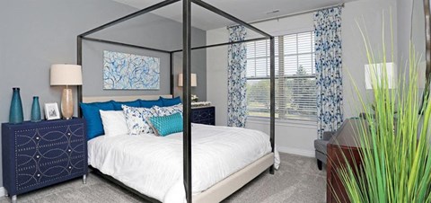 a bedroom with a bed and a large mirror