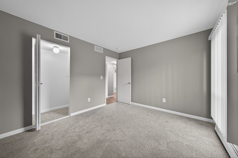 A room with grey walls and carpeted floor.