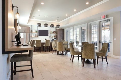 A dining room with a table and chairs.