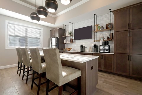 A kitchen with a table and chairs.