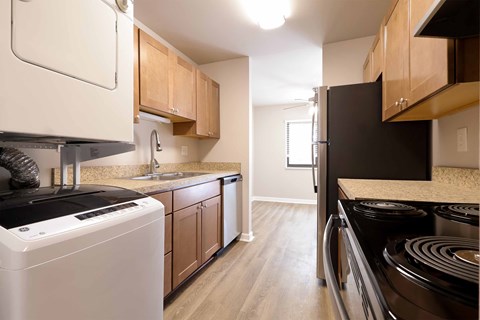 A kitchen with a black stove top oven and white appliances.
