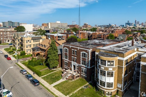 an aerial view of a building with a city in the background
