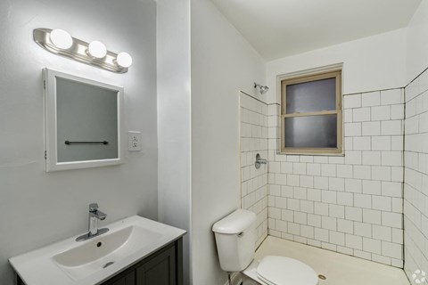 a bathroom with a toilet and a sink and a mirror