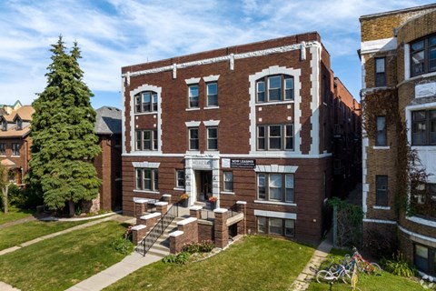 A red brick building with a white sign on the front.