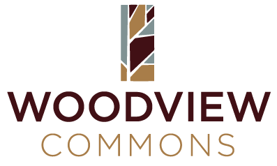 a logo for woodland commons with a red and blue design on a black background