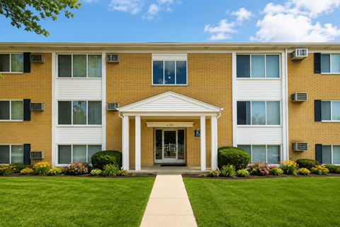 A building with a white entrance and a walkway leading to it.