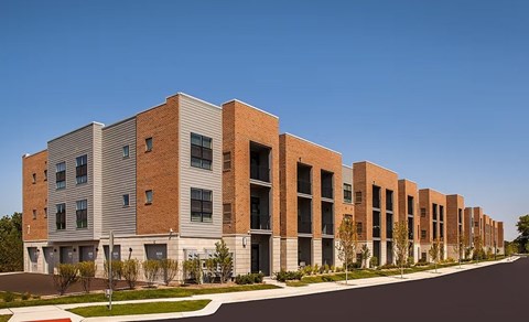 A long row of modern brick apartment buildings.