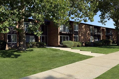 A building with a green lawn in front.