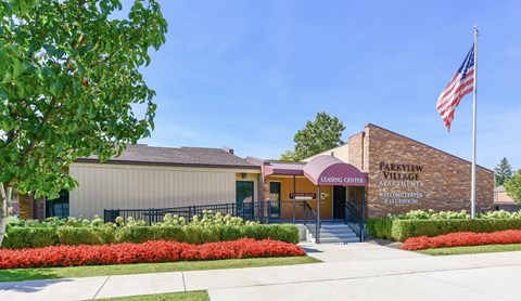 The front of a building with a sign that says Parkview Village Leasing Center.