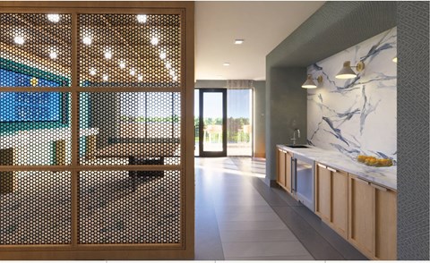 A modern kitchen with a marble backsplash and wooden cabinets.