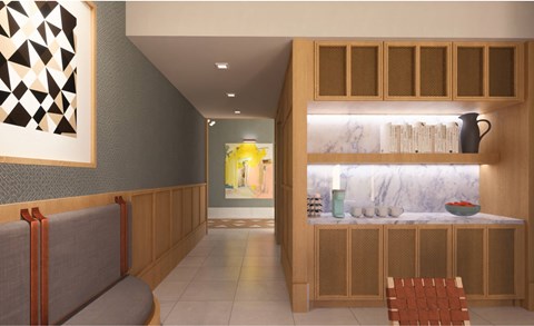 A modern dining area with a grey bench and wooden cabinets.