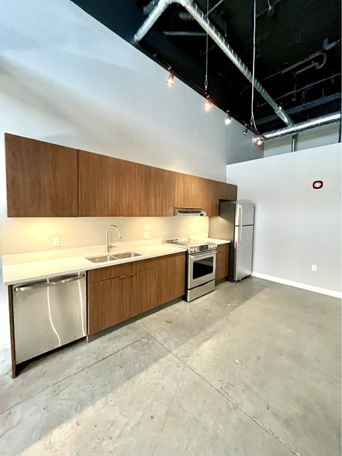 A kitchen with wooden cabinets and stainless steel appliances.