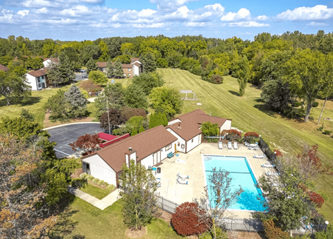 A bird's eye view of a house with a pool in the backyard.