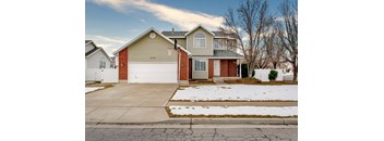 A house with a garage and a driveway in front.