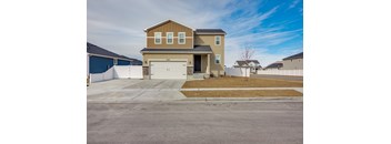 A two-story house with a garage is situated in a residential area.