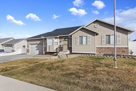A house with a grey roof and a white garage door.