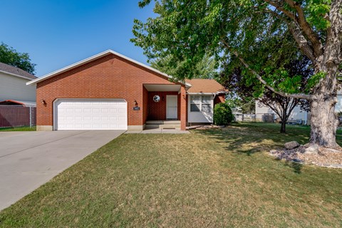 A red brick house with a white garage door.