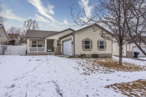 the front of a house with snow on the ground