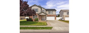 A house with a grey roof and a white garage door.