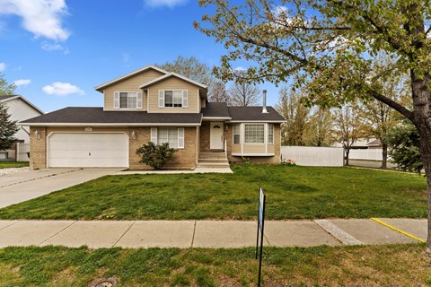 A house with a brown roof and a white garage door.