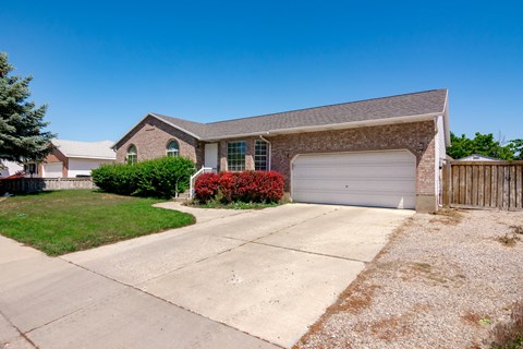 A house with a garage and a driveway in front.